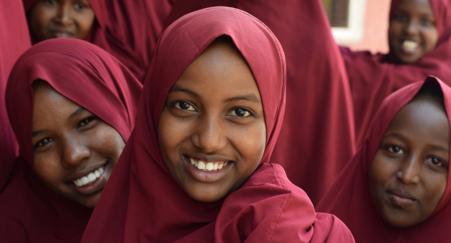 Three Kenyan girls smiling.